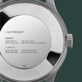 The back of the Adsum + Timex MK1 with the text 'I AM PRESENT' engraved