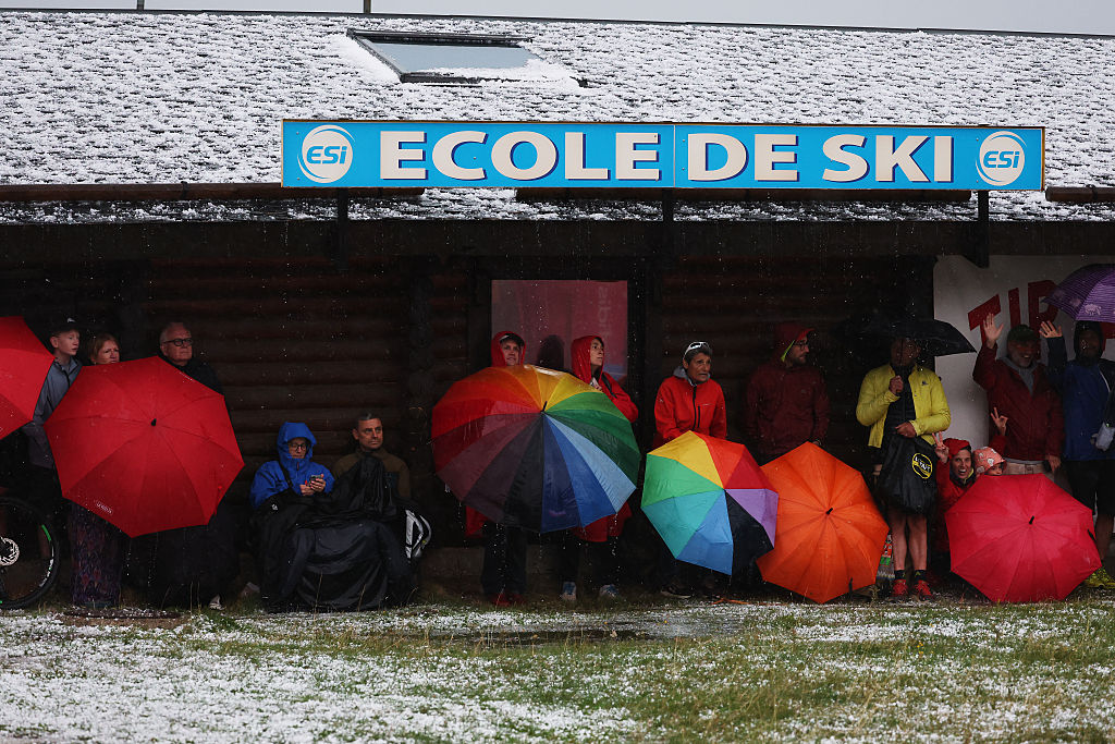 Fans shelter from the hail on stage three Vuelta a Espana 2026