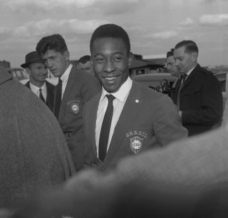 Pele on his arrival at London Airport from West Germany. He travelled with the Brazilian team for a friendly match against England at Wembley Stadium