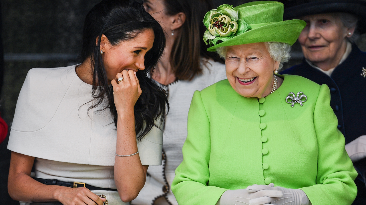 Queen Elizabeth II sitts and laughs with Meghan, Duchess of Sussex during a ceremony to open the new Mersey Gateway Bridge on June 14, 2018 in the town of Widnes in Halton, Cheshire, England