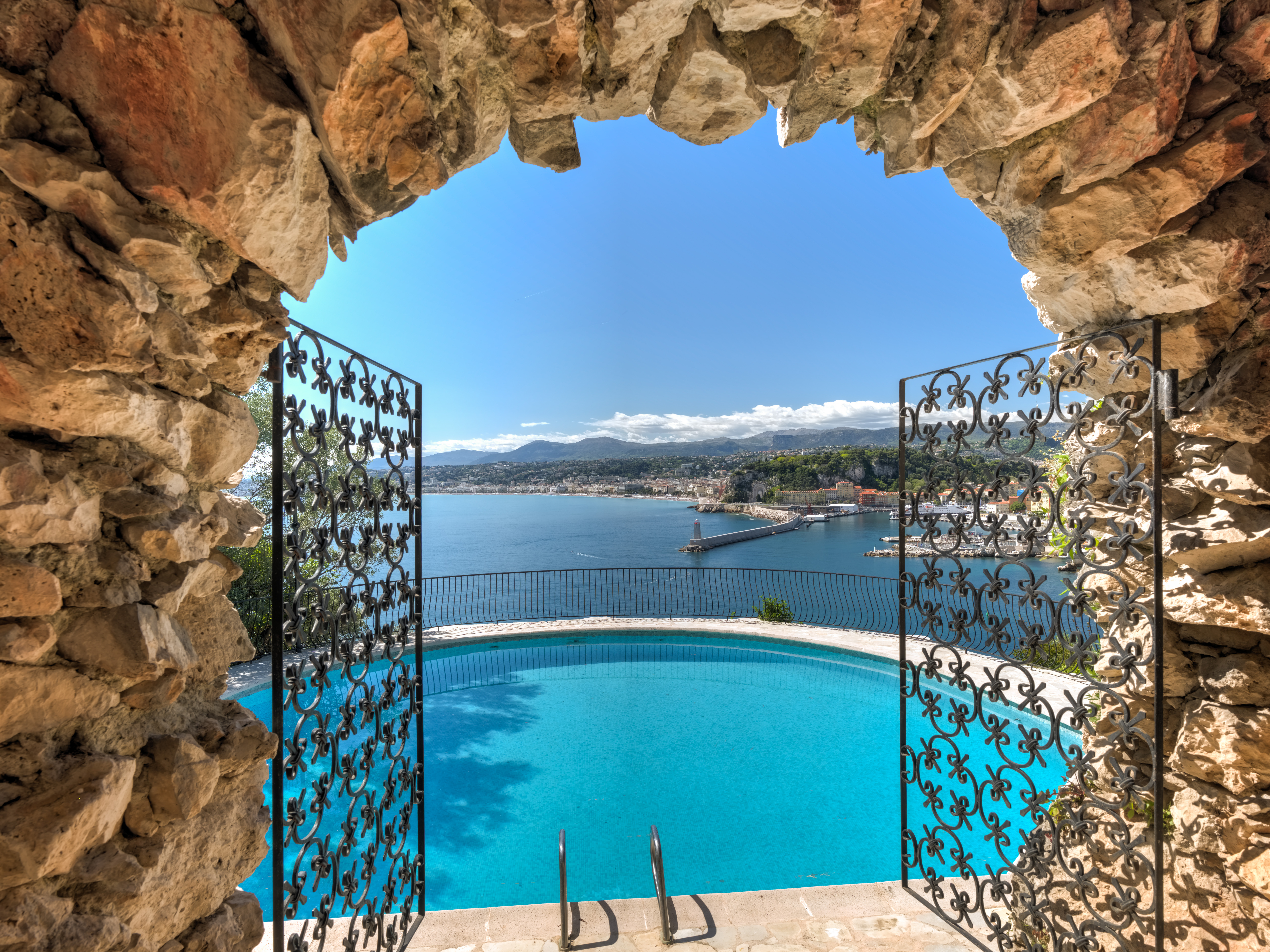 Gates open to an outside pool which overlooks the ocean.