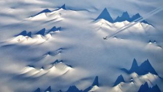 Aerial view of US Air Force C-17 flying over mountains and glaciers of Victoria Land, Antarctica.