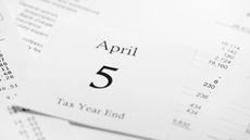 April 5th calendar page on background of accounts sheets and financial tables