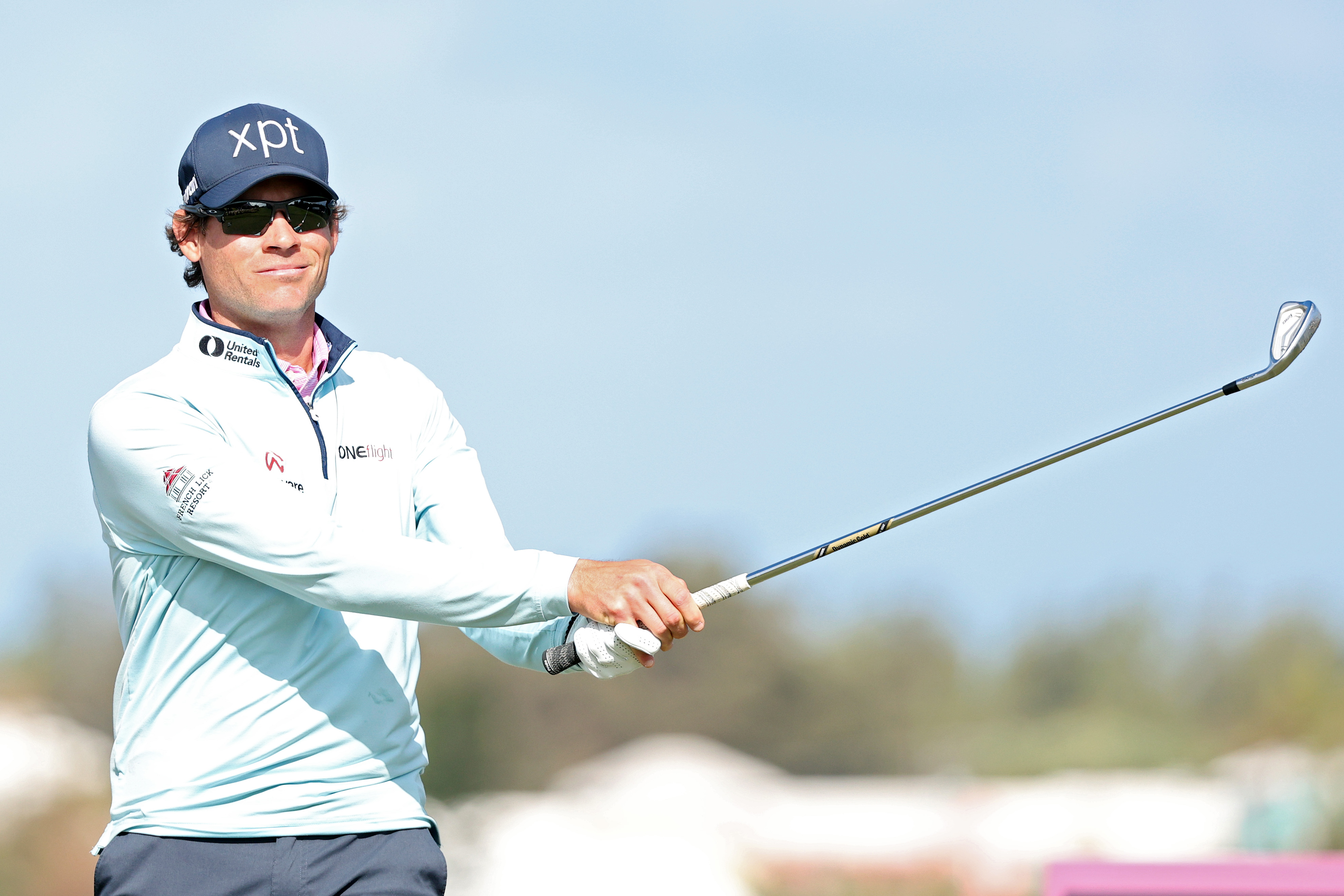 Adam Schenk hits an iron shot and watches its flight