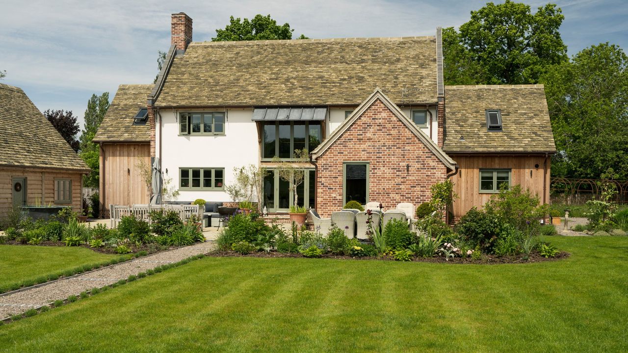 Grass lawn with stripes in front of house and patio seating area