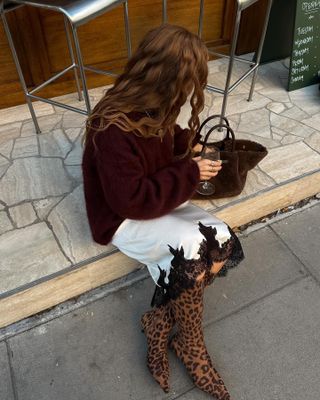 Lace skirt outfits: @rebeccaferrazwyatt wears a jumper with a lace skirt and leopard boots