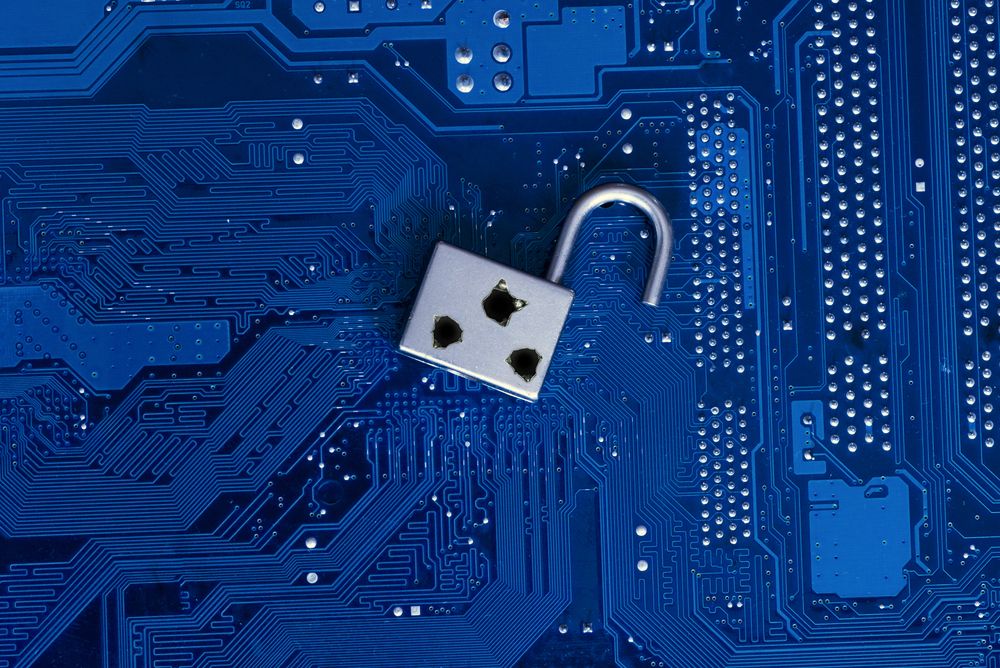 A security flaw depicted by a padlock with bullet holes on a circuit board