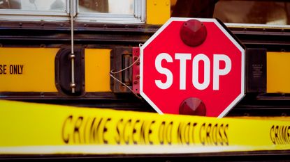 A school bus behind caution tape