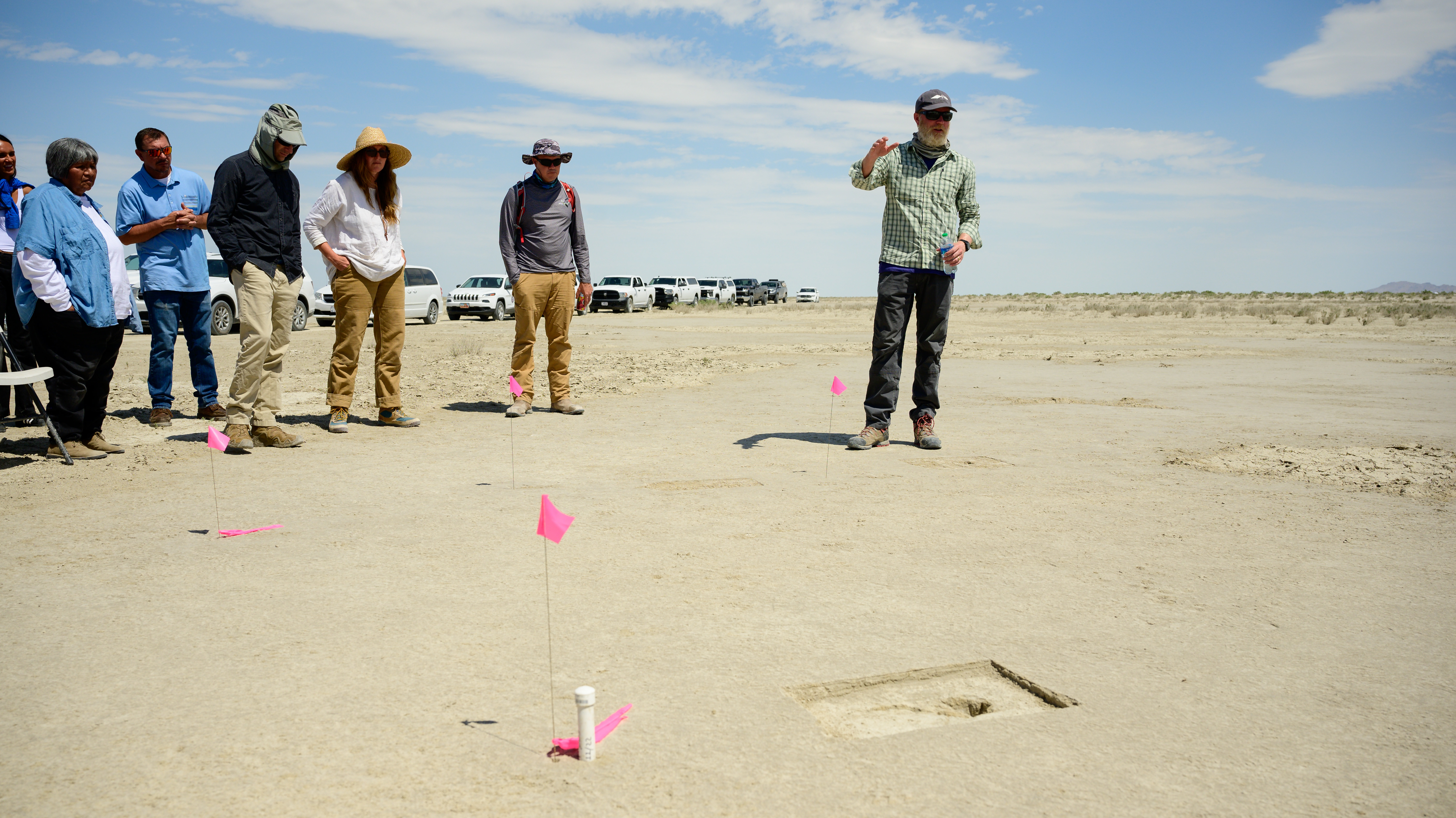 Researchers stand next to one of the ghost footprints uncovered at Hill Air Force Base.