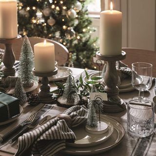 Dining table with candles and wire brush Christmas trees