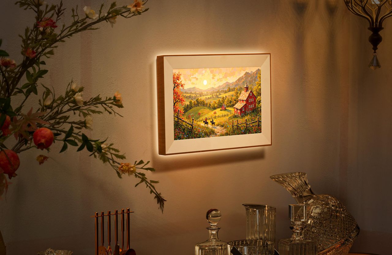 Pexar Starlight digital photo frame mounted to a wall at night, illuminating the wall