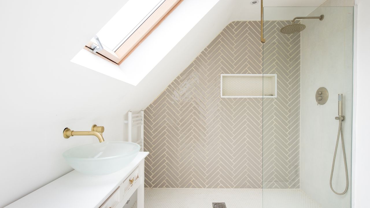 attic bathroom with a shower stall and sink