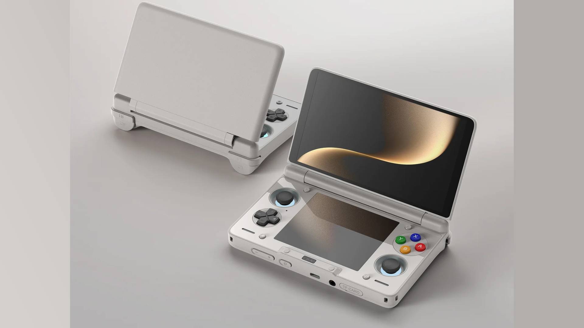 Ayn Thor clamshell handheld in beige with green, blue, yellow, and red face buttons with off white backdrop.