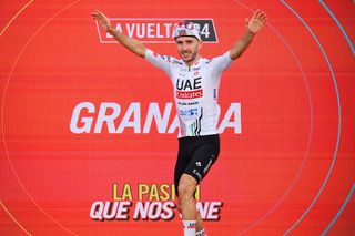 GRANADA SPAIN AUGUST 25 Adam Yates of The United Kingdom and UAE Team Emirates celebrates at podium as stage winner during the La Vuelta 79th Tour of Spain 2024 Stage 9 a 1785km stage from Motril to Granada UCIWT on August 25 2024 in Granada Spain Photo by Tim de WaeleGetty Images