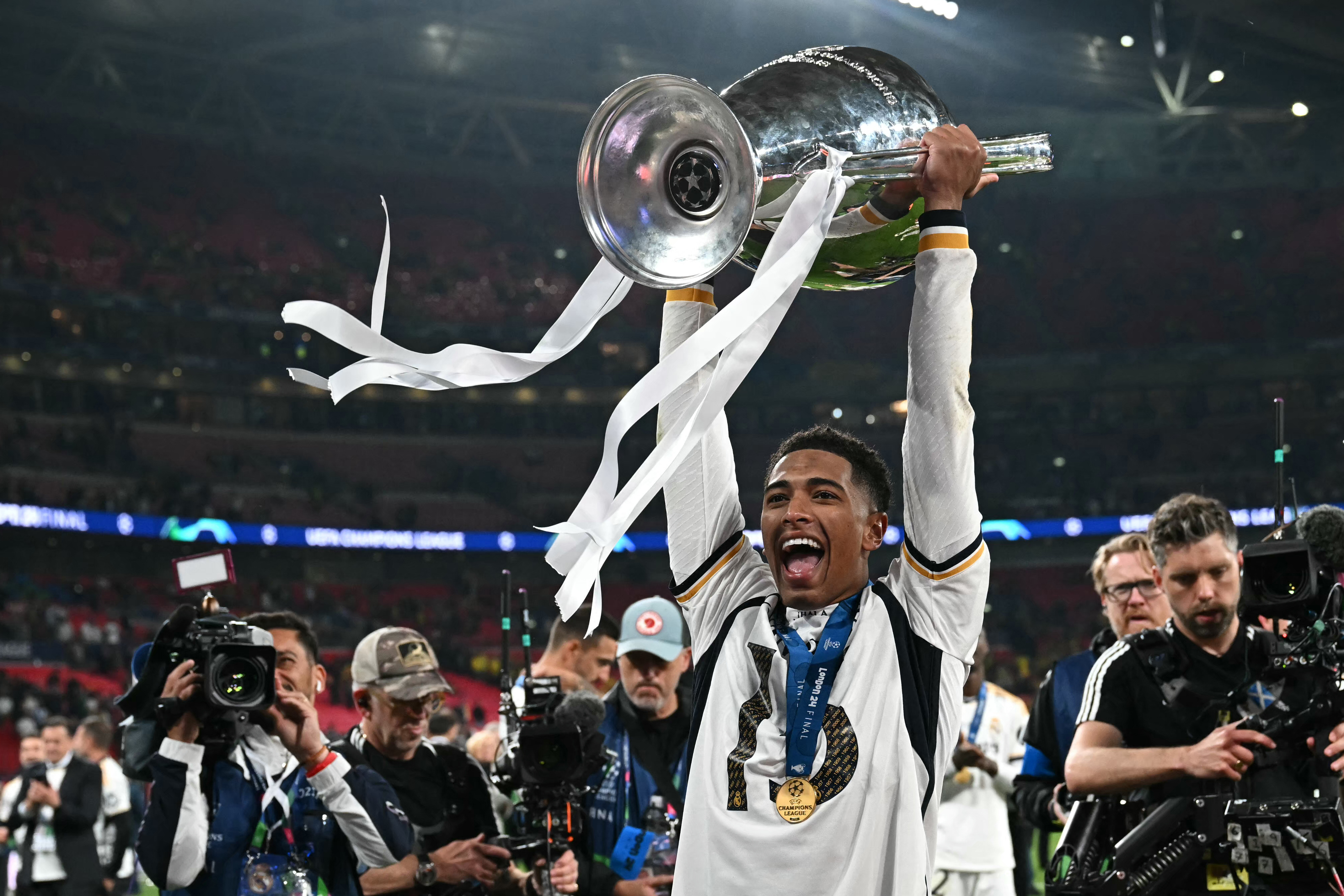 Jude Bellingham lifts the Champions League trophy after Real Madrid's win over Borussia Dortmund in the final in June 2024.