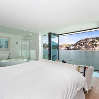 bedroom with white walls and river view