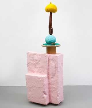 Pink stone with candle holders on