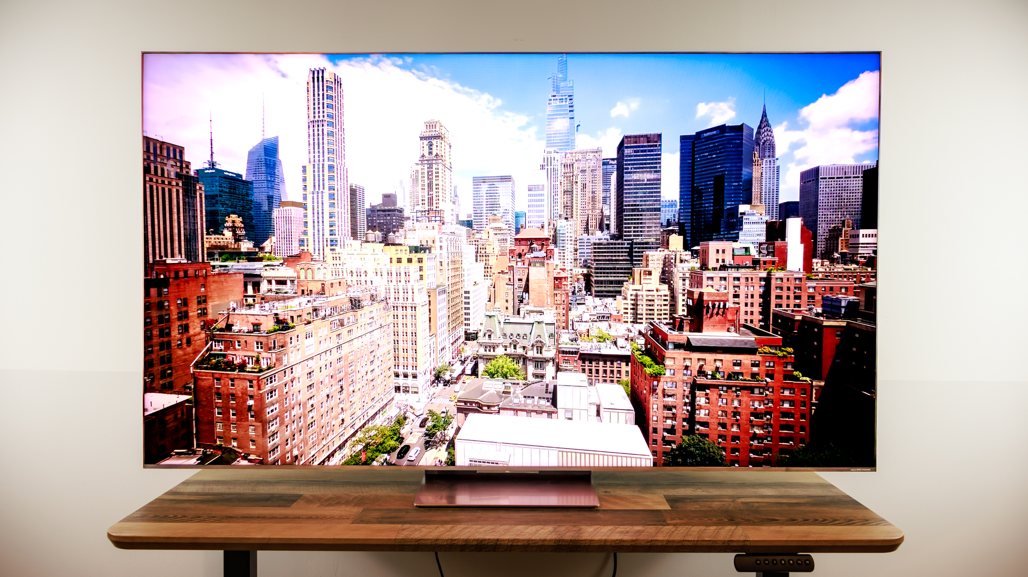 A 75-inch TCL QM8L TV on a desk