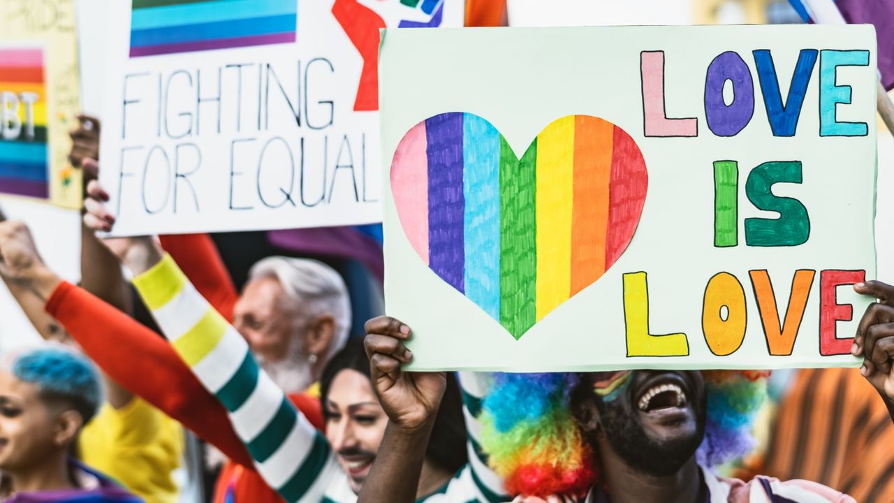 LGBT+ History Month: Happy Multiracial people celebrating gay pride event - Group of friends with different age and race fighting for gender equality rights