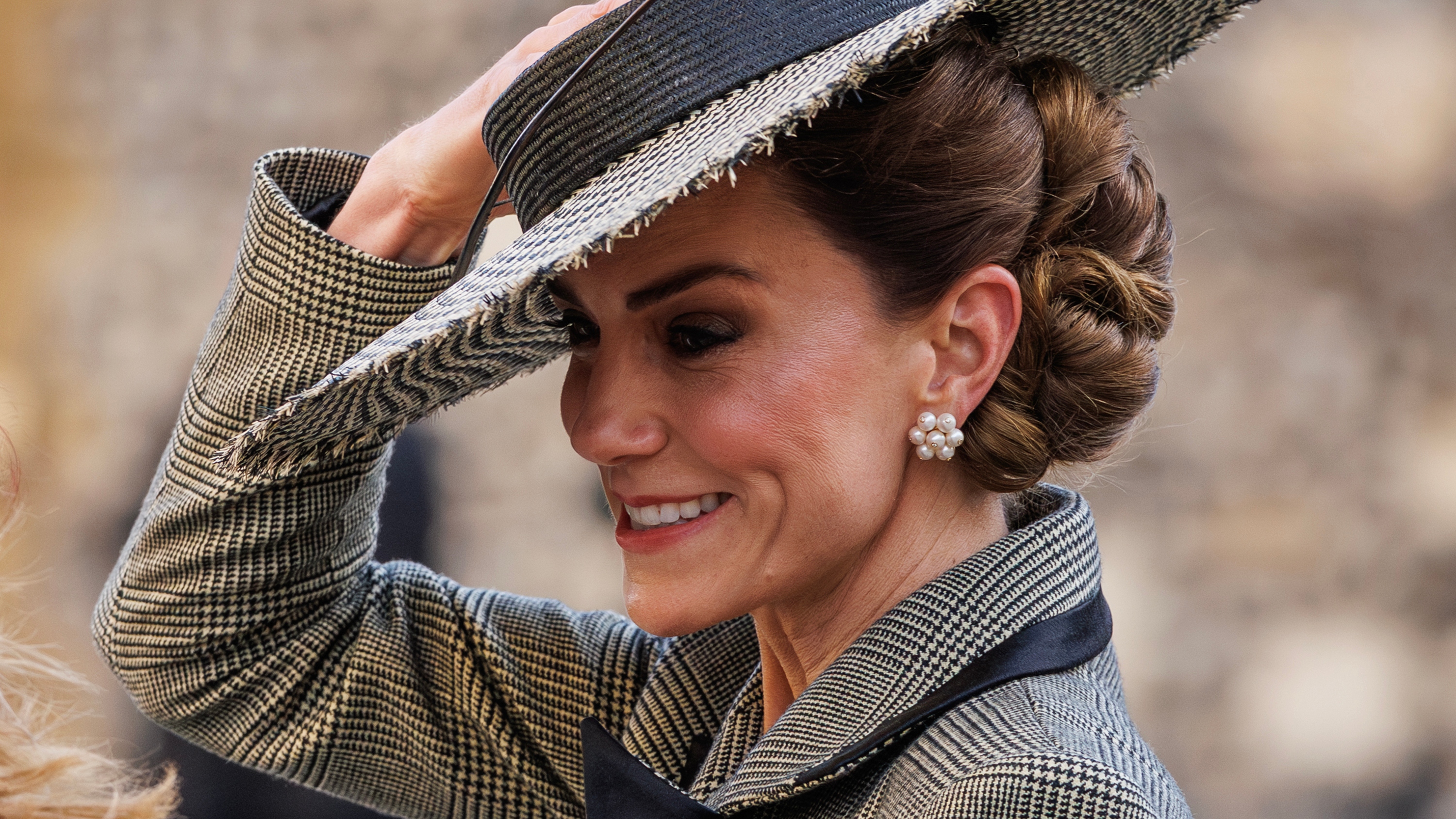 Catherine, Princess of Wales holds on to her hat as she leaves after Dame Sarah Mullally was installed as the first ever female leader of the Church of England at Canterbury Cathedral on March 25, 2026
