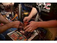 The participating team players were working together to jointly install a processor-specific copper cylinder.