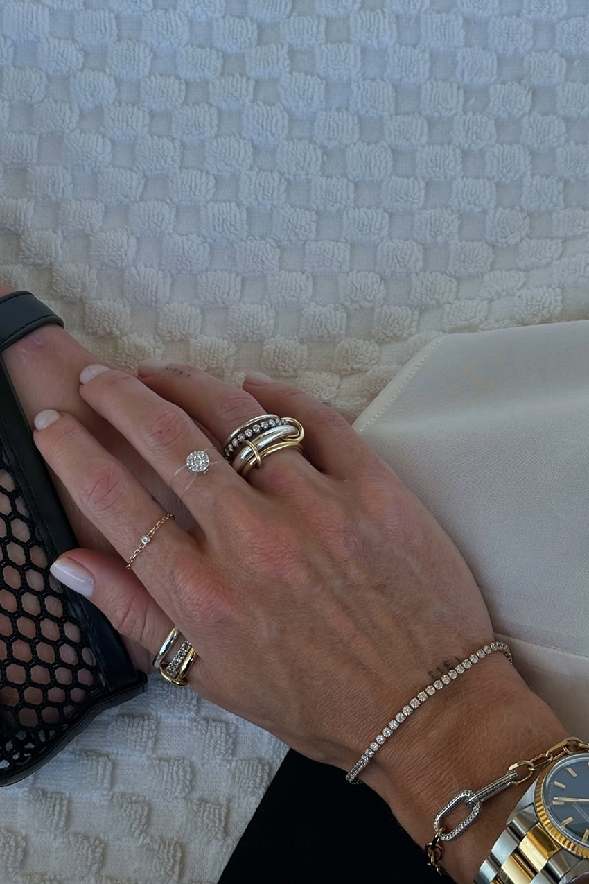 a woman wearing fine jewelry rings and a tennis bracelet