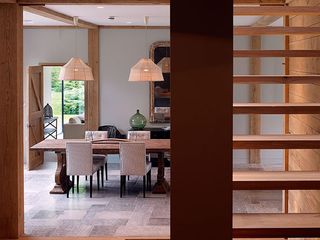 Dining room table and chairs and wooden staircase to the right