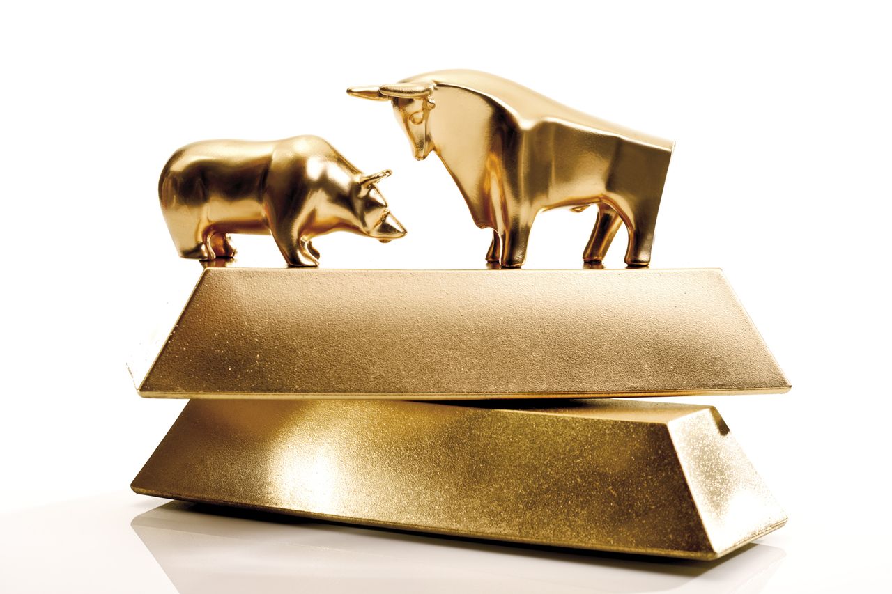 Bull and bear sculptures by gold bars