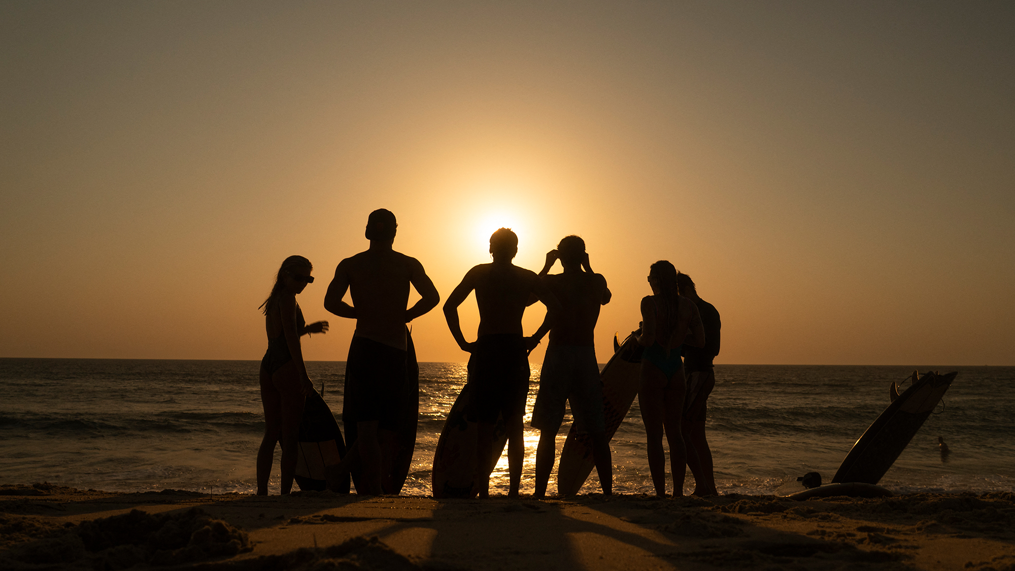 surfers watch a partial solar eclipse From the beach in Lege-Cap-Ferret on August 12, 2026. (Photo by Tania Buijten / AFP via Getty Images)