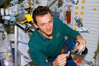 European Space Agency (ESA) astronaut Pedro Duque, seen here preparing a snack aboard the space shuttle Discovery in 1998, flew chorizo as a spicy treat for him and his STS-95 crewmates.