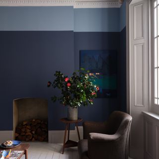 Farrow & Ball Wine Dark paint colour in a living room with a plant and an armchair