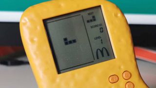 Close up of Mcdonald's Mcnugget handheld with Tetris game on screen