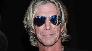 Duff McKagan posing for a photograph wearing sunglasses