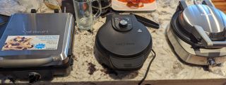 Testing three waffle makers (Cuisinart, Cheffman and Breville) on a kitchen counter