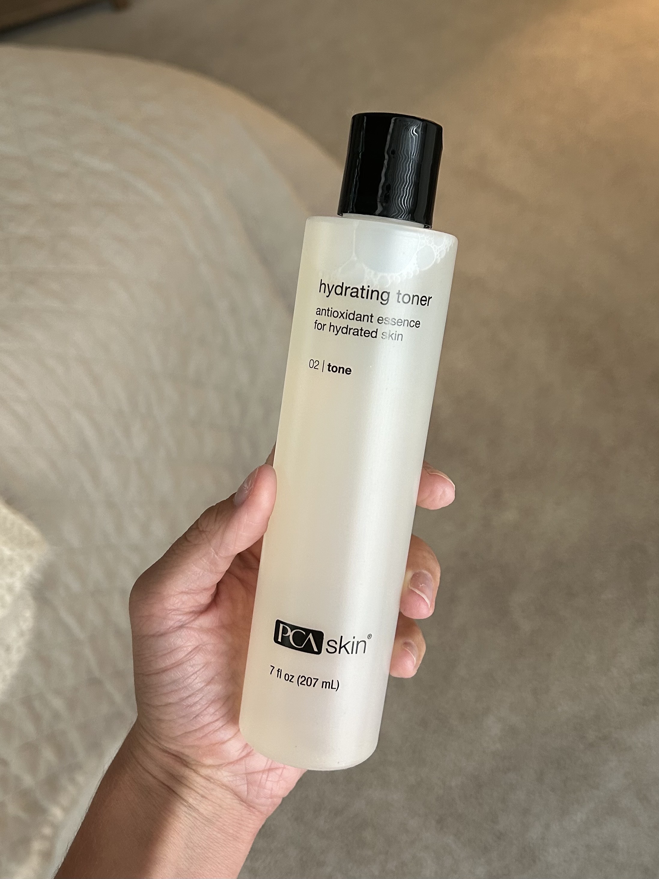 Alyssa Brascia holding the PCA Skin Hydrating Toner.