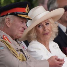 Queen Camilla wears all white and cries while looking at husband King Charles, who has been called brave during the VJ Day 80th anniversary
