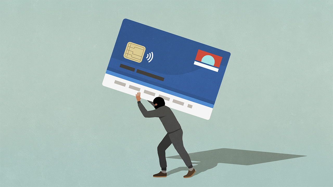 Cartoon image of cybercriminal holding giant credit card