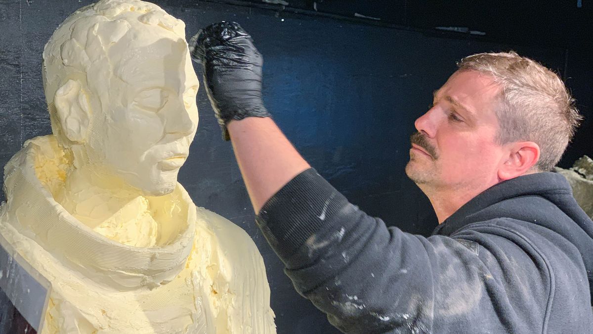 One of the lead sculptors, Alex Balz, chisels the fine details on a butter sculpture of astronaut Michael Collins. This year&rsquo;s annual butter display honoring the first moon landing took about 500 hours to complete, 400 of which were spent in a 46-degree cooler.