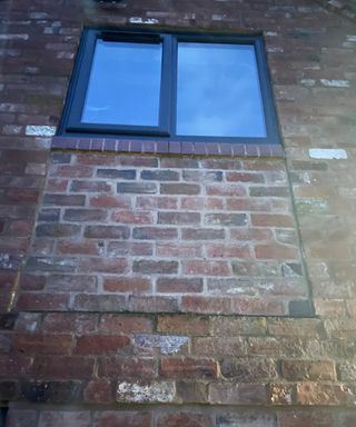 A window above a bricked-up window