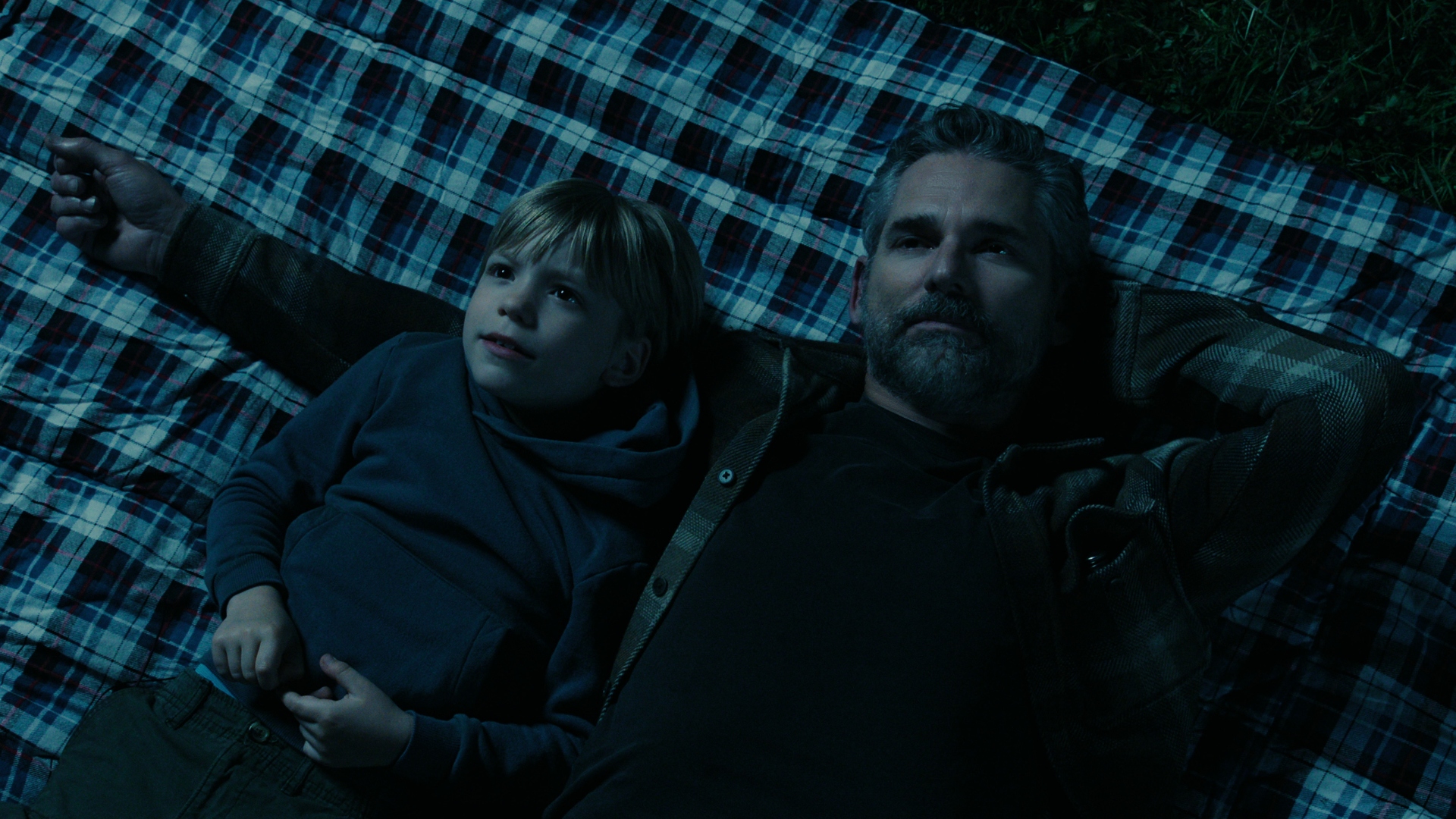 Kyle lies with his son, Caleb, on a picnic blanket in Untamed
