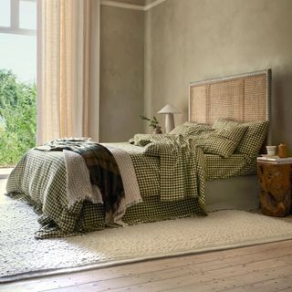 Botanical Green Gingham Linen Blend Duvet Cover on a bed against beige walls. 