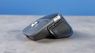 A photo of the Logitech MX Master 4 on a stone surface with a blue background