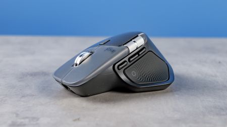 A photo of the Logitech MX Master 4 on a stone surface with a blue background