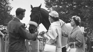 The Queen and Princess Margaret with the Queen's racehorse Restoration in the unsaddling enclosure at Ascot, 19th June 1958