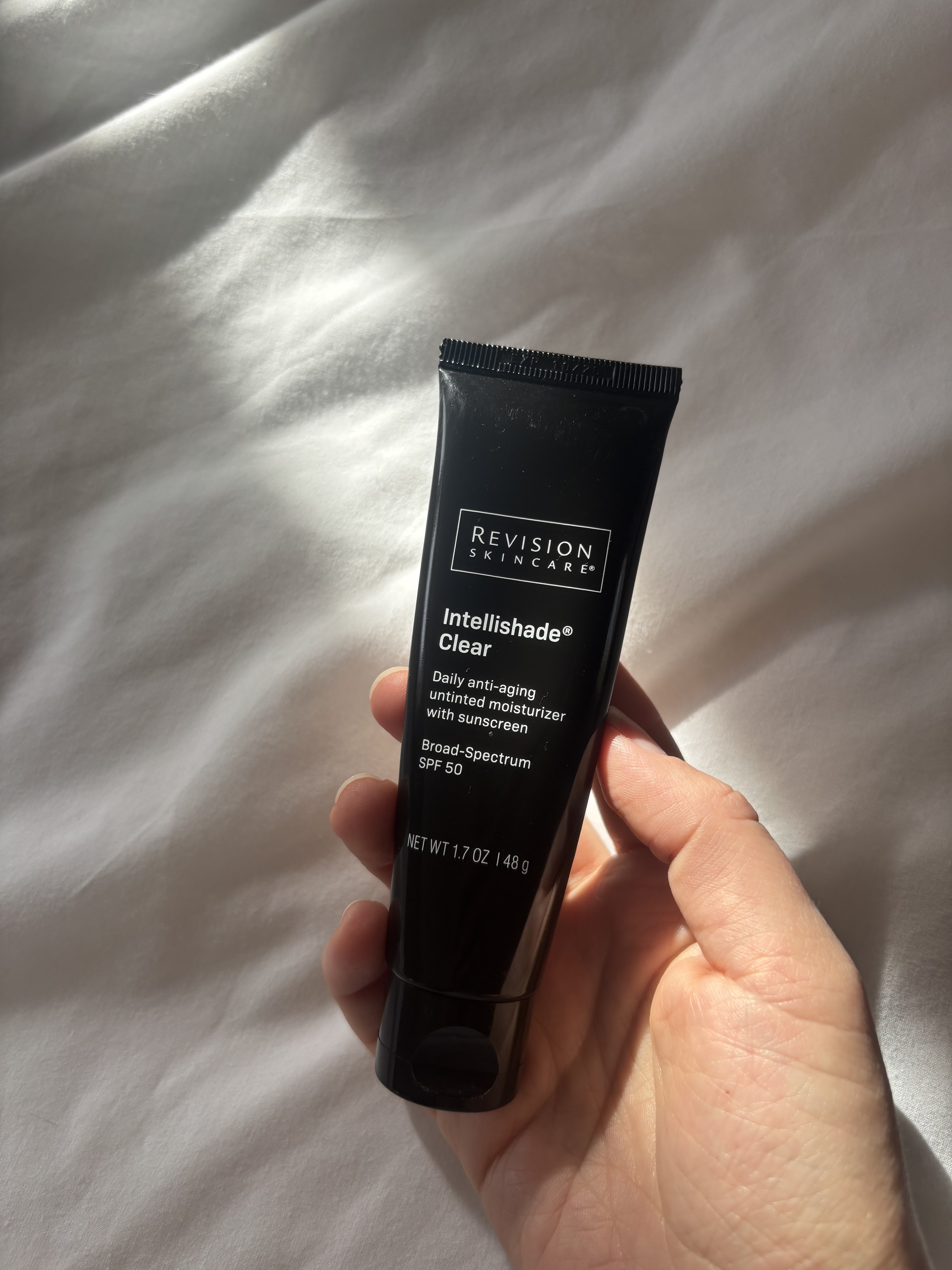 Perdita Nouril holding the Revision Skincare Intellishade Clear