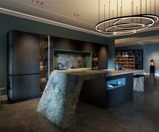 luxury fitted kitchen in dark blue tones with large angular island unit