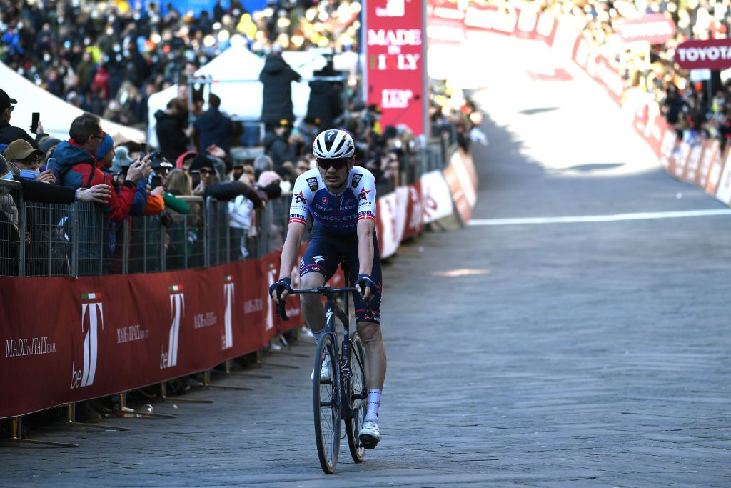 SIENA ITALY MARCH 05 Kasper Asgreen of Denmark and Team QuickStep Alpha Vinyl crosses the finish line during the Eroica 16th Strade Bianche 2022 Mens Elite a 184km one day race from Siena to Siena Piazza del Campo 321m StradeBianche WorldTour on March 05 2022 in Siena Italy Photo by Tim de WaeleGetty Images