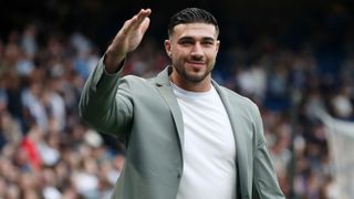 Tommy Fury of World XI inspects the pitch prior to Soccer Aid for UNICEF 2024 at Stamford Bridge in a white t-shirt and grey suit jacket