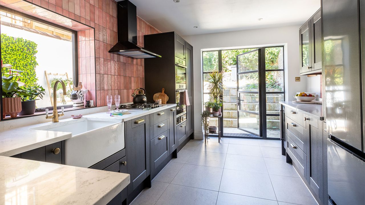 black kitchen cabinets with pink tiles and crittal doors