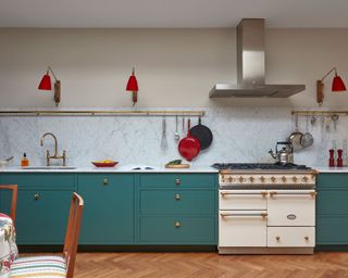 Kitchen color with green cabinets and red pendant lights